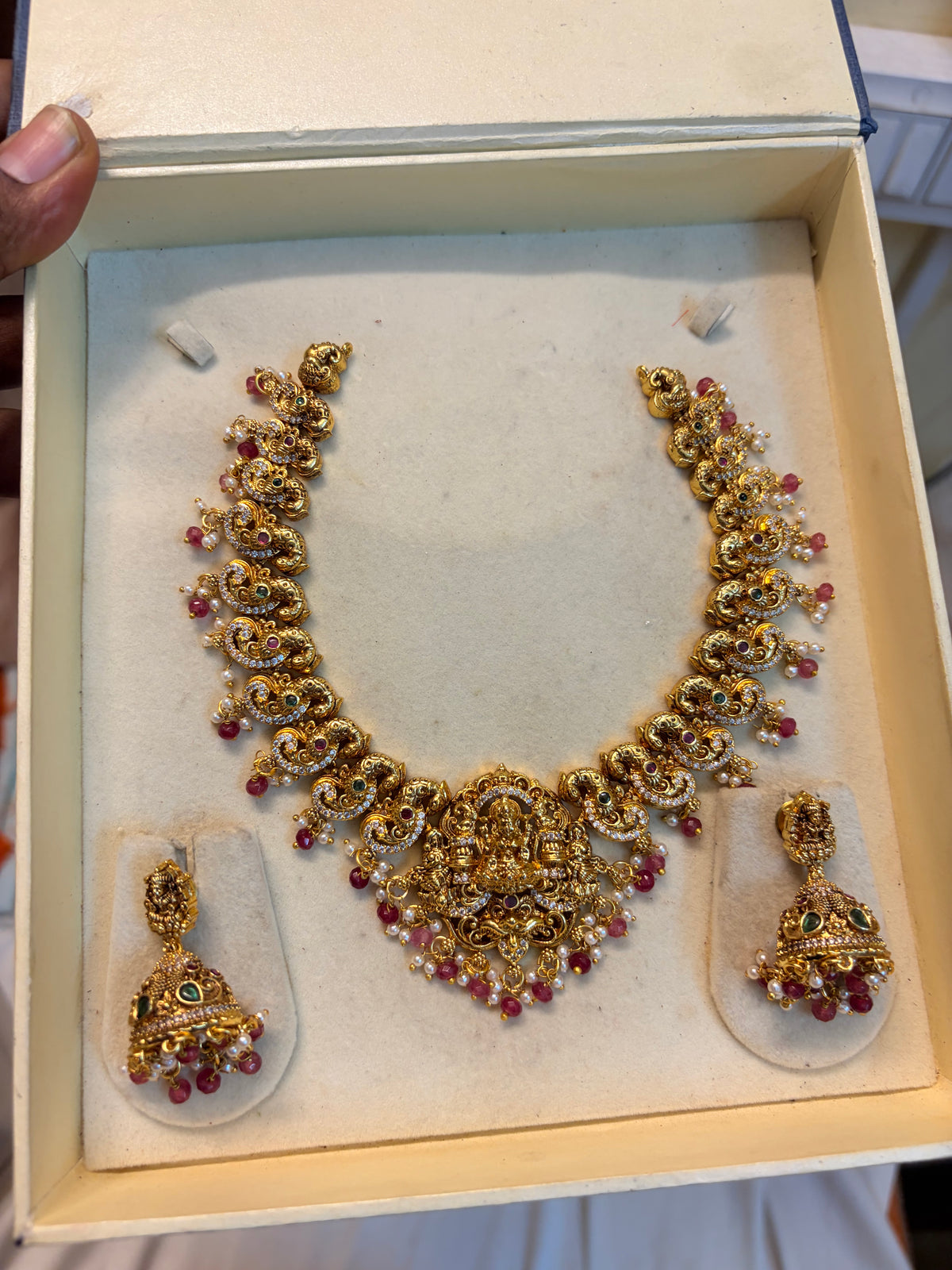 Gold Nakshi jadau peacock necklace set with red beads accents