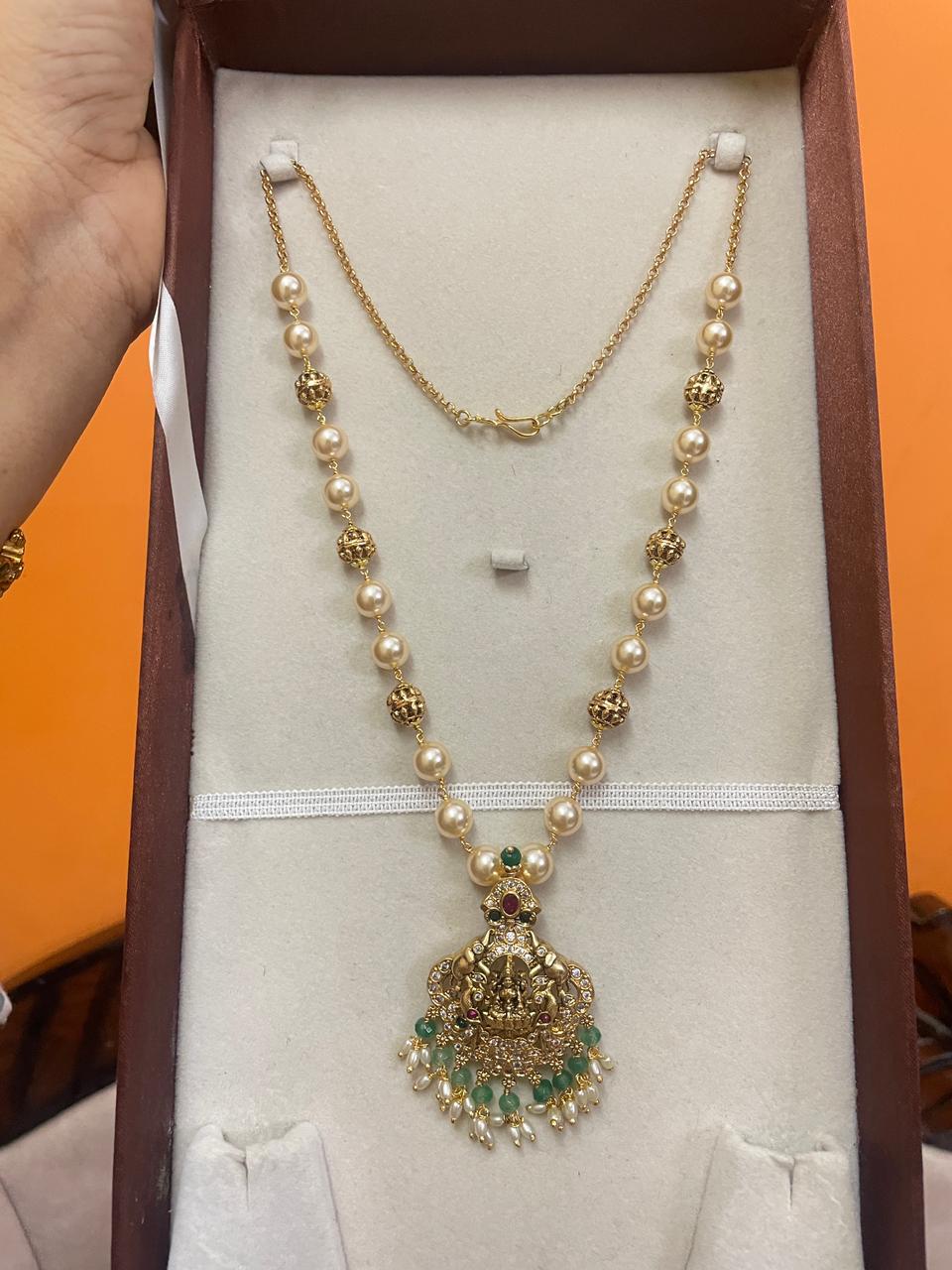 Swarovski pearls gold antique finish locket premium quality
