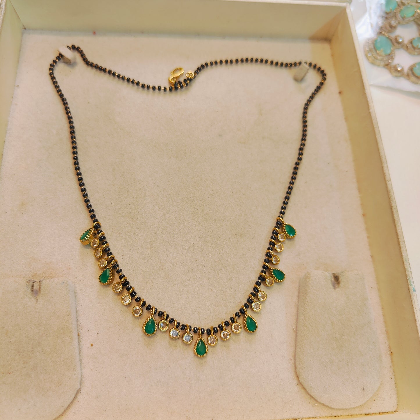 Elegant emerald polki droplets black beads chain