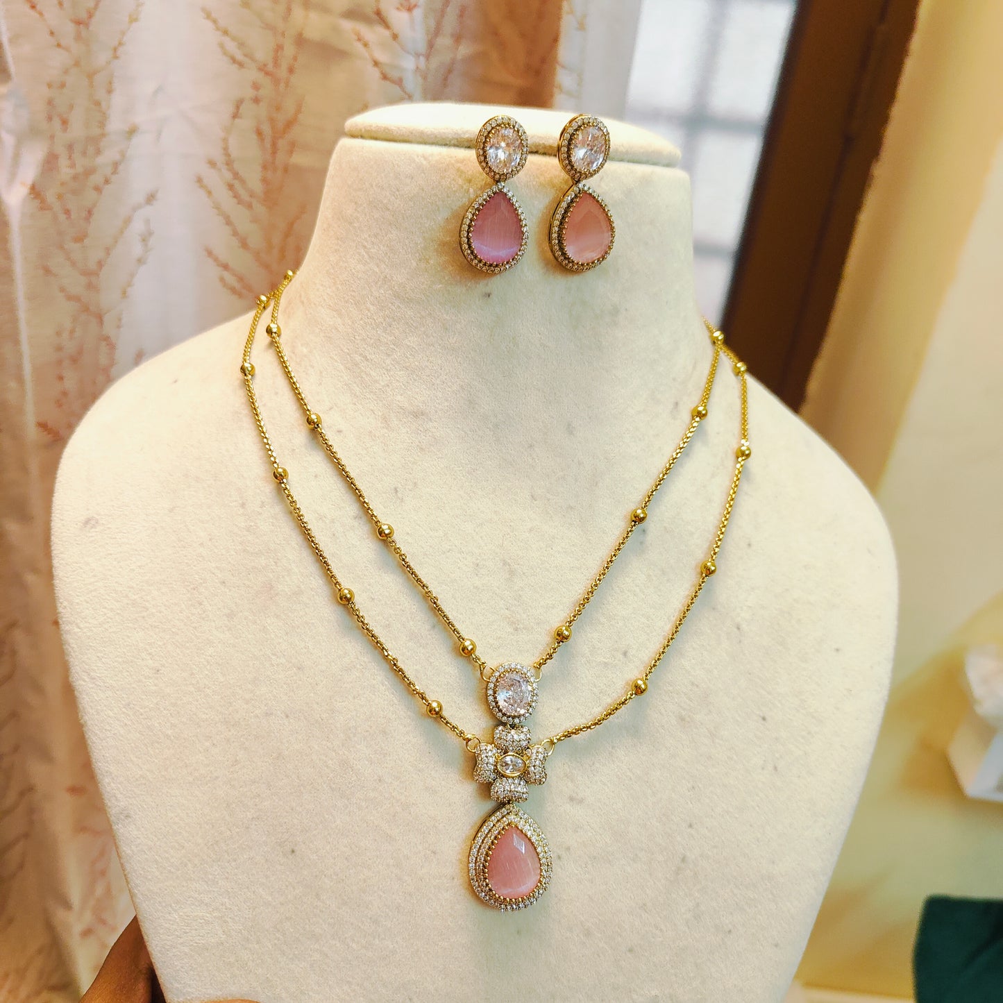 Elegant dual layer chain with pink teardrop pendant