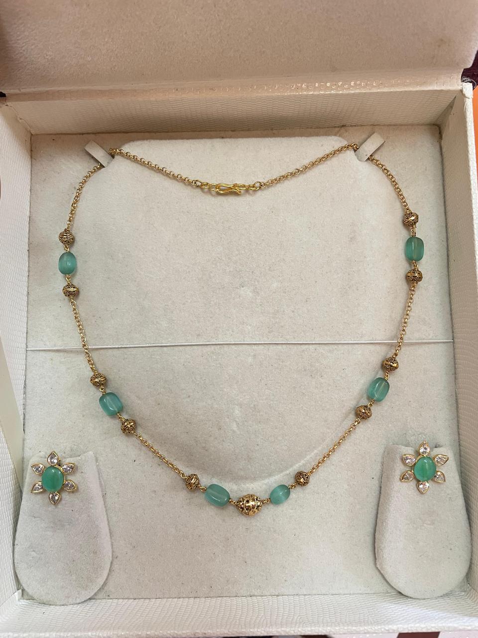 Delicate gold chain with floral earrings