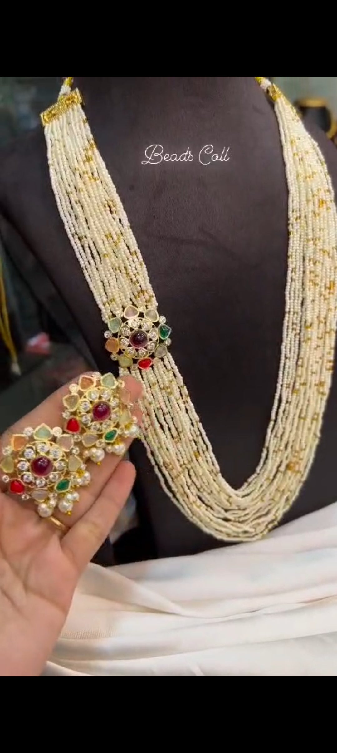 Multi-strand pearl haram with navratna floral pendant