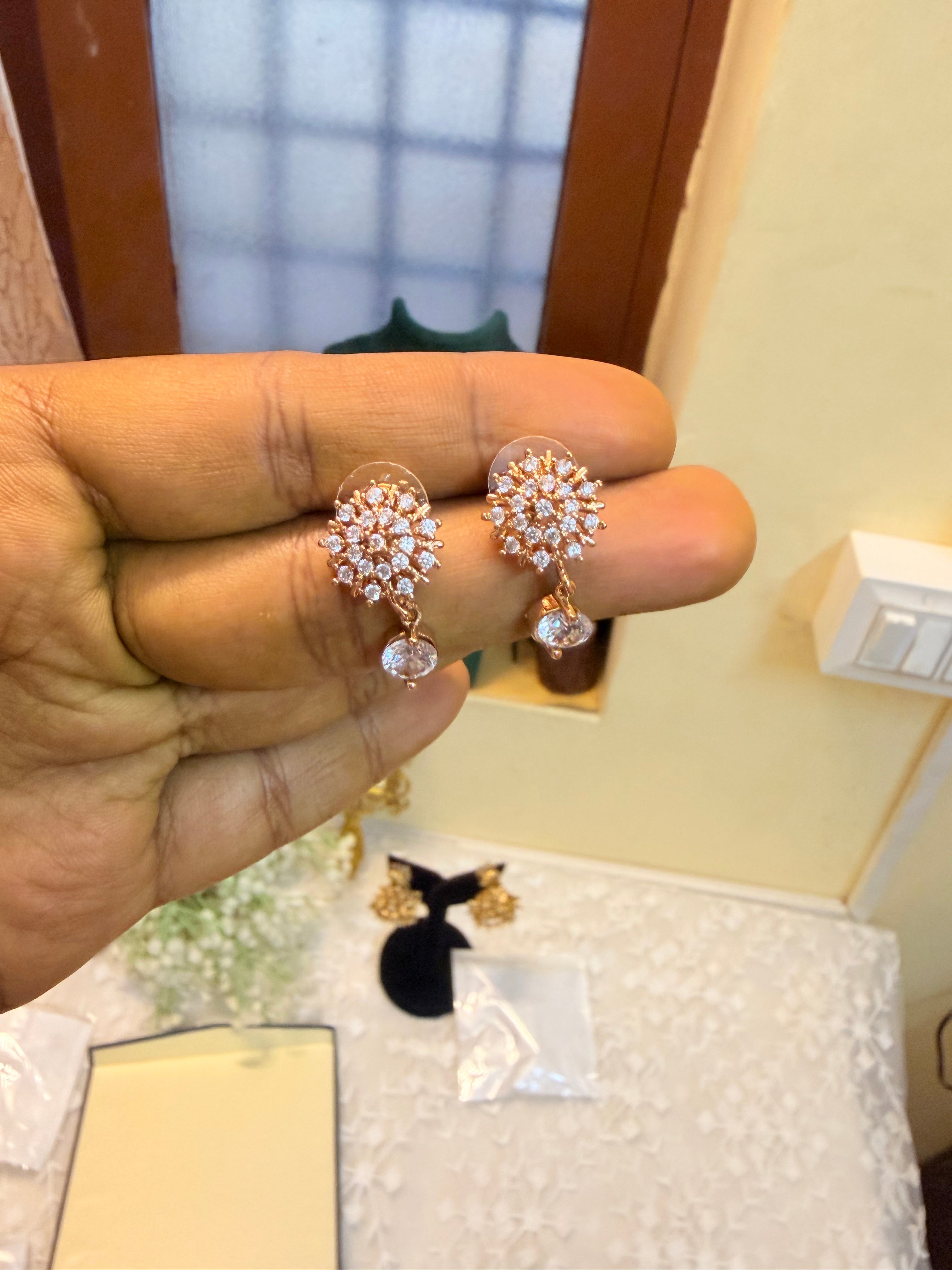 Rose gold Cz sunburst drop earrings
