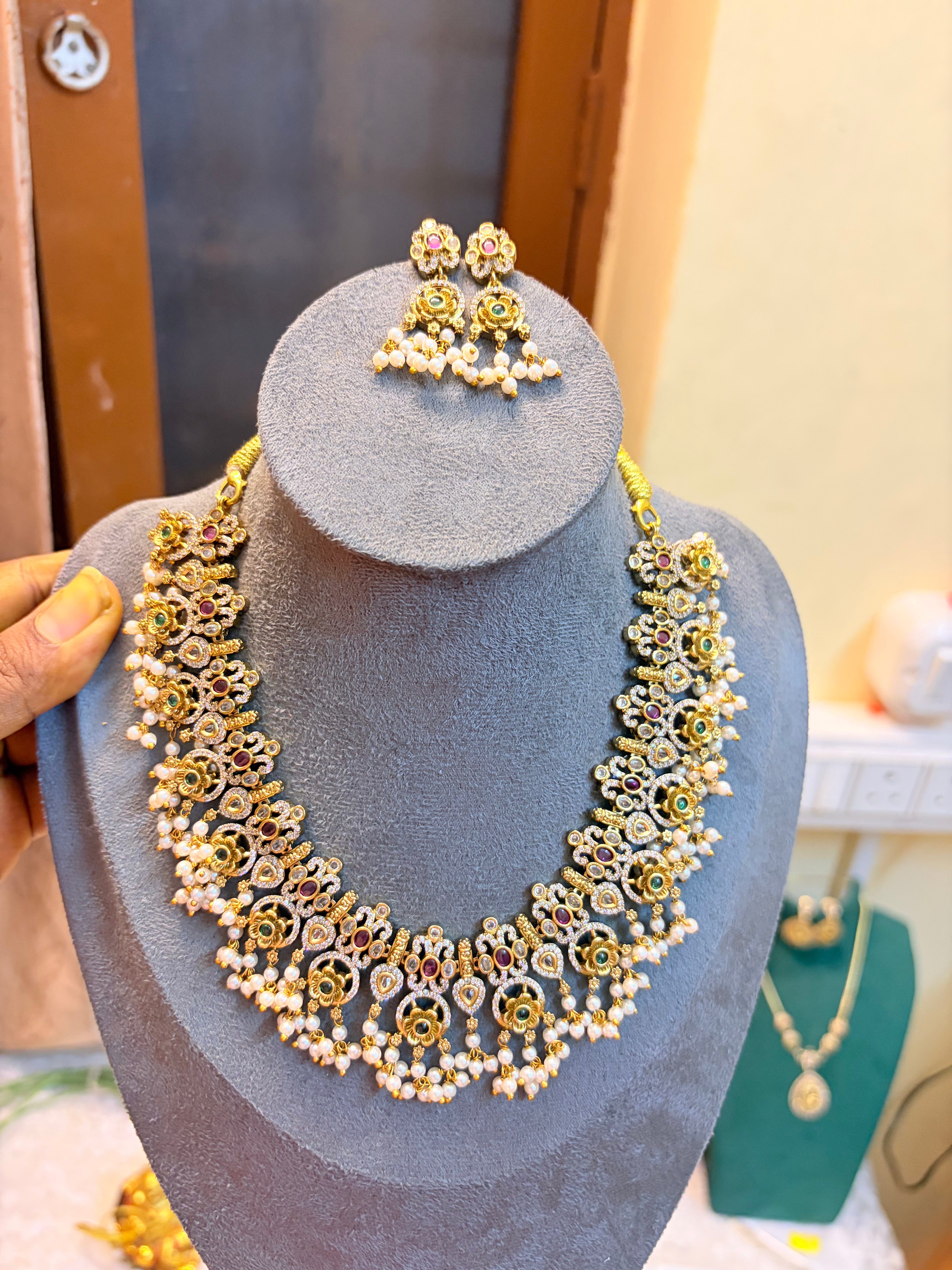 Gold antique finish jadau necklace set with pearl accents