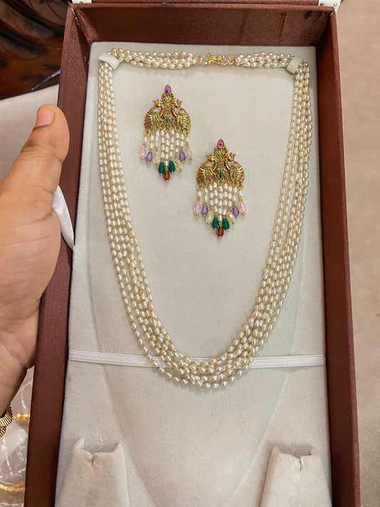 Multi-strand pearl chain with peacock earrings