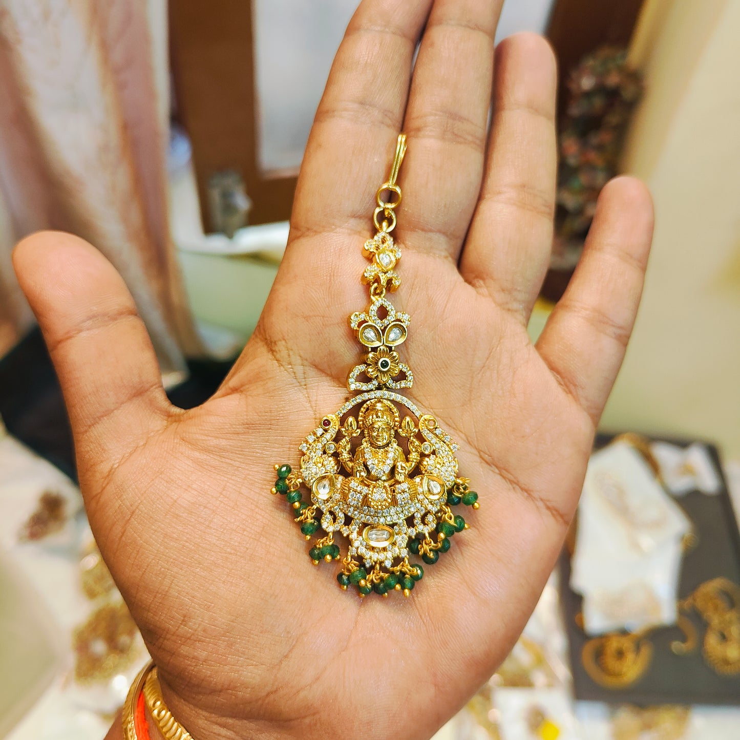 Divine lakshmi maang tikka with green bead drops